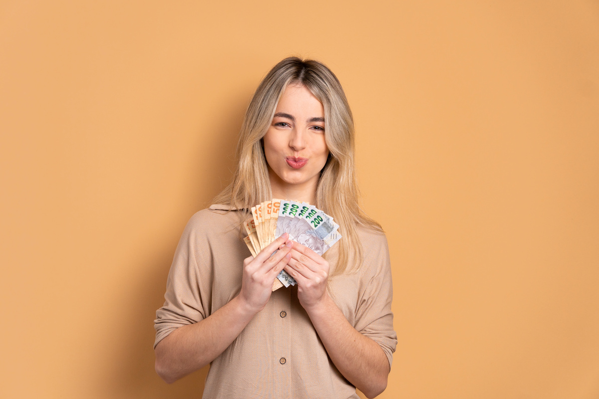 happy woman with money, brazilian real